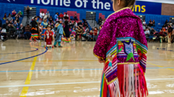 Native american child in regalia at pow wow