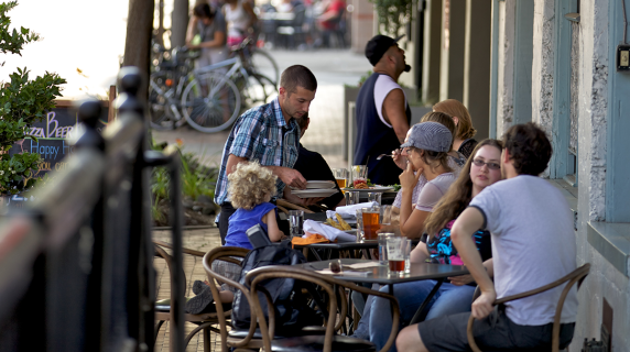 Happy families and friends dine outside a cafe in Eugene