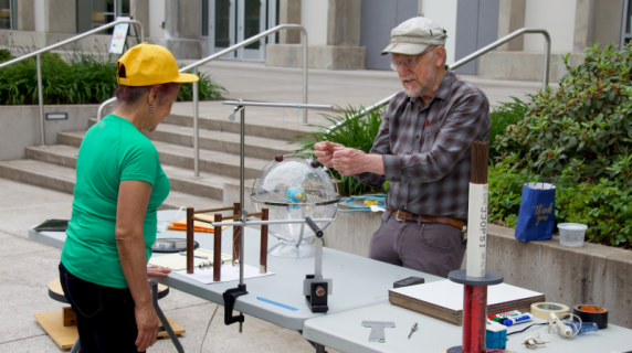 a science instructor demontrating an experiment at an event