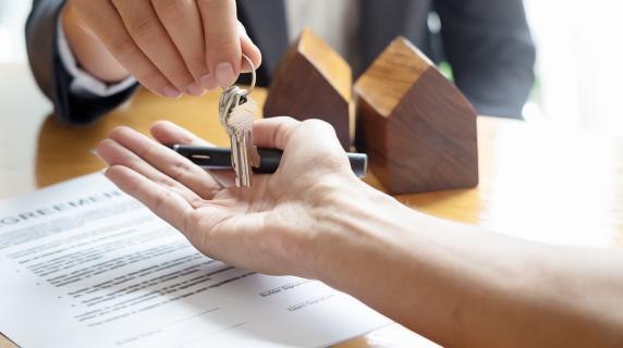 real estate handing house keys to a client