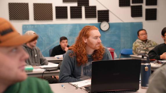 a student with a laptop in class