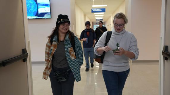 two students walking down a hallway