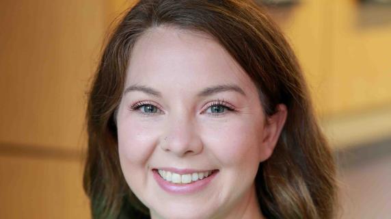 A student in green scrubs