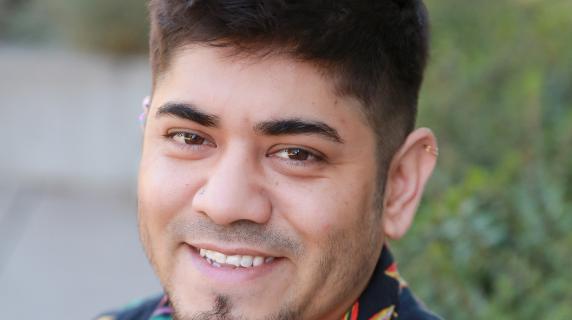 A student with a goatee and a hawaiian shirt