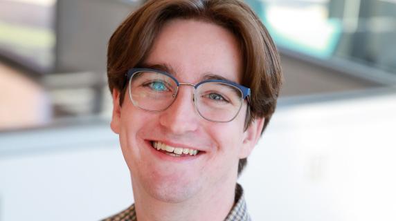 A male student wearing glasses