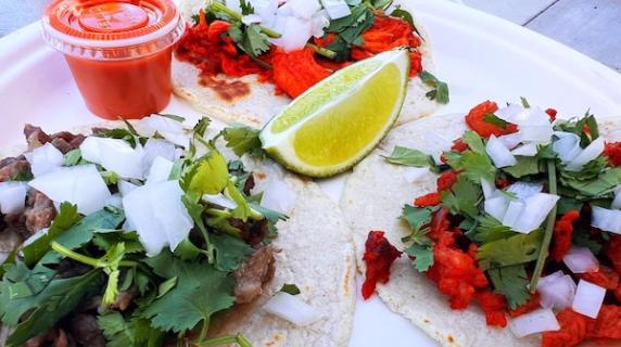 fresh tacos with cilantro, onion, lime, and salsa on corn tortillas