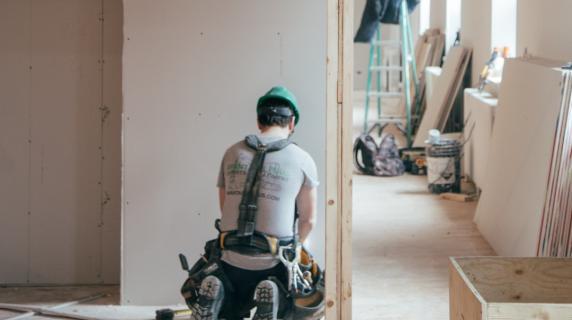 a contractor works on building a house