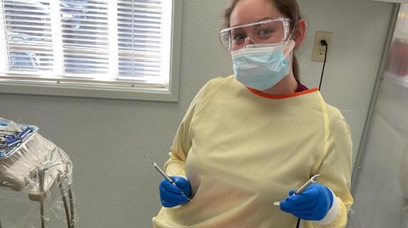 dental hygiene student practices on another student in a clinic