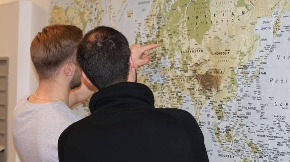two students review a map