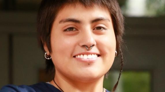 A student with nose ring in scrubs