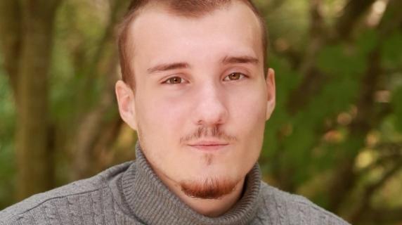 A man in a sweater with short hair