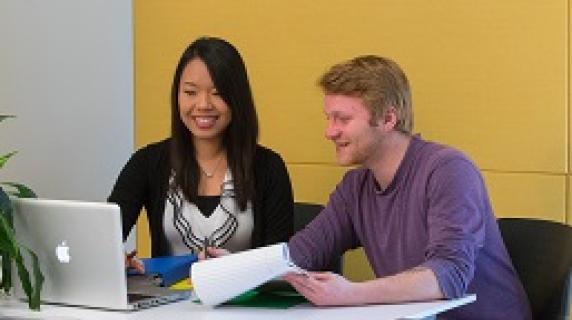 an advisor helping a student in a brightly colored room