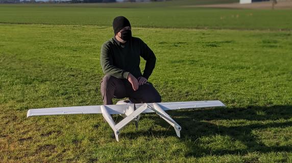 A student wtih a fixed wing drone