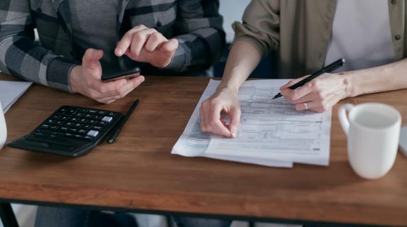 Two people working on their taxes