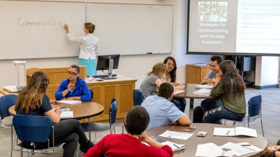 students discuss diversity and communications in a business class