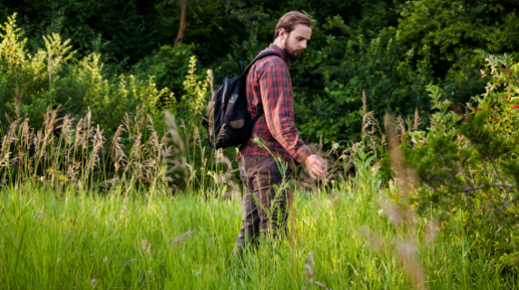 a man in plaid hiking and admiring nature