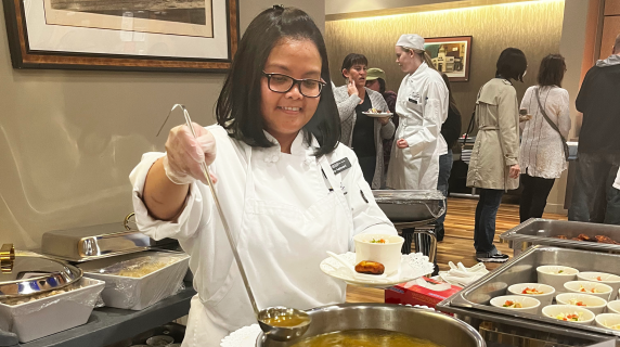 a young woman ladles soup at the Renaissance Room, LCC's restaurant