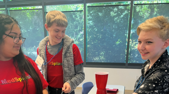 high schoolers in MedSplash shirts smiling and working together