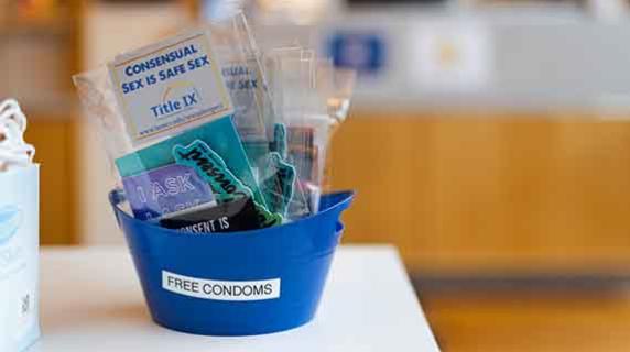 a full container labeled "free condoms"