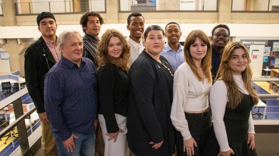 student government officials lined up and smiling in the library