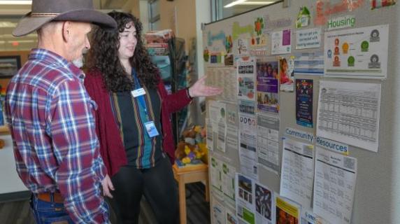a friendly LCC employee helping a student navigating community resources like SNAP and housing