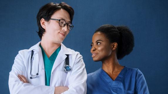 A student in the LPN to RN program smiles with a doctor