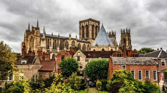 York Minister Cathedral in England, a grand old building against a dramatic cloudy sky