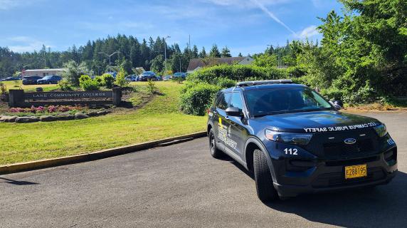 a Public safety vehicle parked in front of the LCC sign