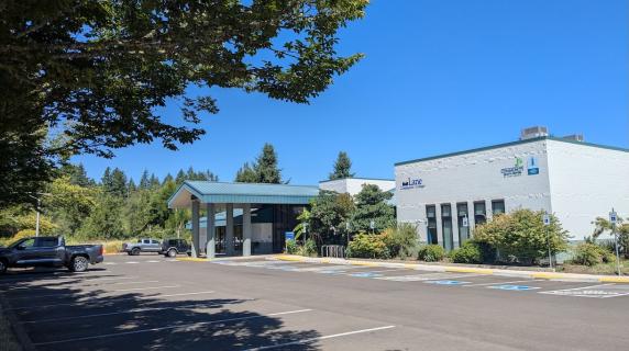 The renovated Cottage Grove Center, a welcoming building framed by trees and blue sky