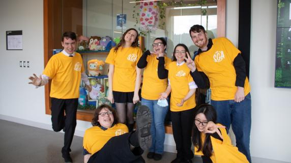 the 2026-2027 student government represenetatives wearing matching yellow shirts and posing goofily 
