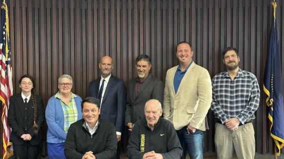 The board of education, with the chair and vice-chair seated, with the student rep at far left