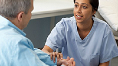 Nursing Assistant holding hands with resident