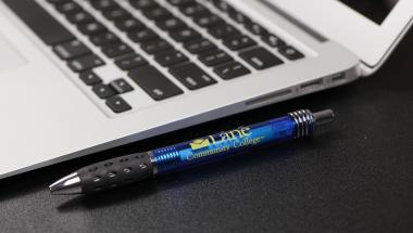 Laptop computer with a LCC branded pen next to it