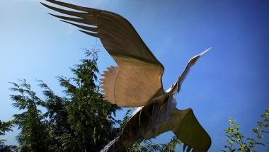 Metal bird in flight sculpture 