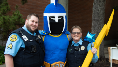 public safety officers posting with ty the titan mascot