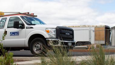 a truck and construction area with a rain garden in the foreground