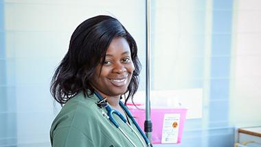 Headshot of Angelica, in nursing scrubs, wearing a stethascope around her neck