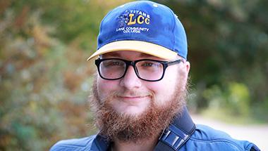 Headshot of Terrance-James, outside wearing an LCC hat