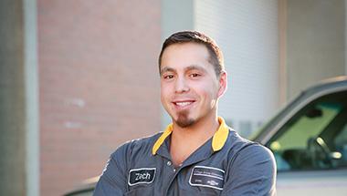 Headshot of Zechariah, in an automotive uniform