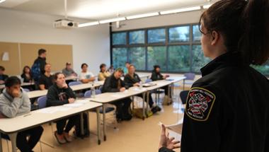 A female firefighter from Pleasant Hill-Goshen fire district talks to our EMT program