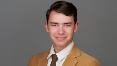 Michael Olson, wearing a tan suit and tie