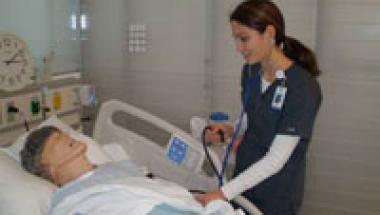 nurse checking on patient bedside