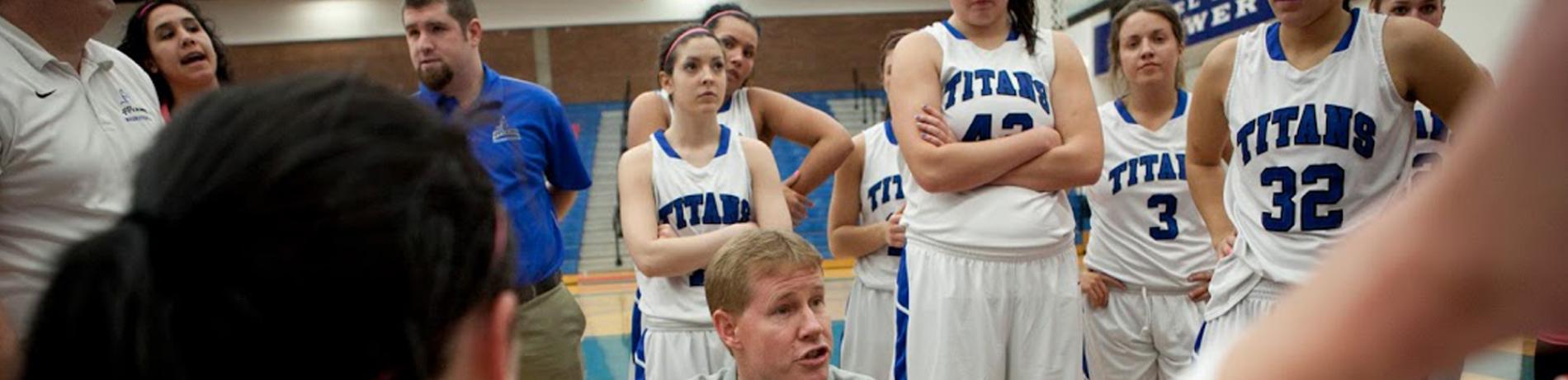 The Lane TItans Women's Basketball Team in a huddle during a game