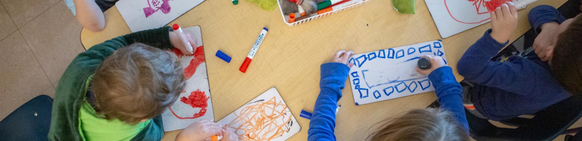 Children at table with markers