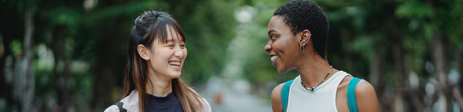 two students talking and smiling