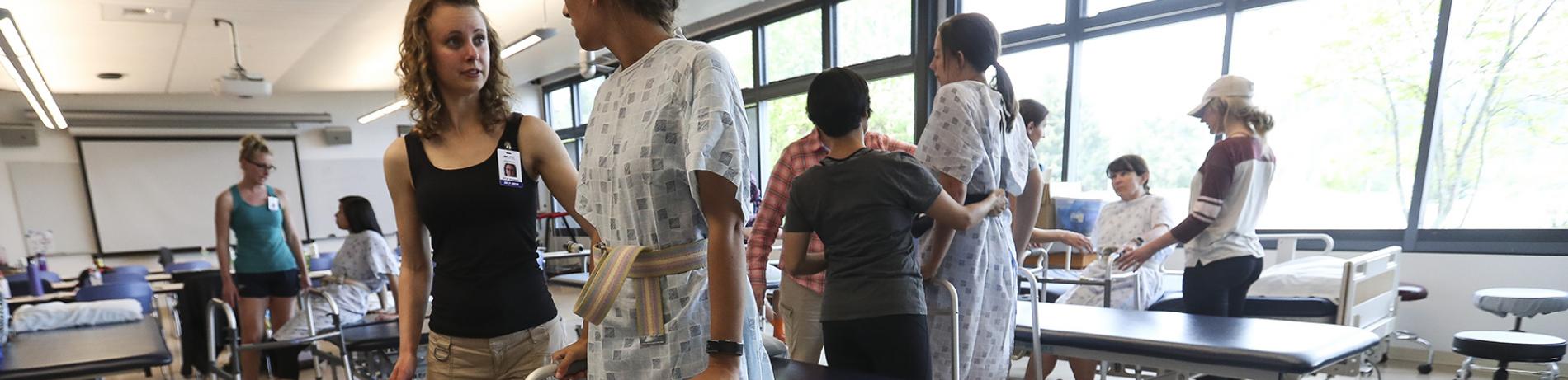 Health Professions students helping a patient