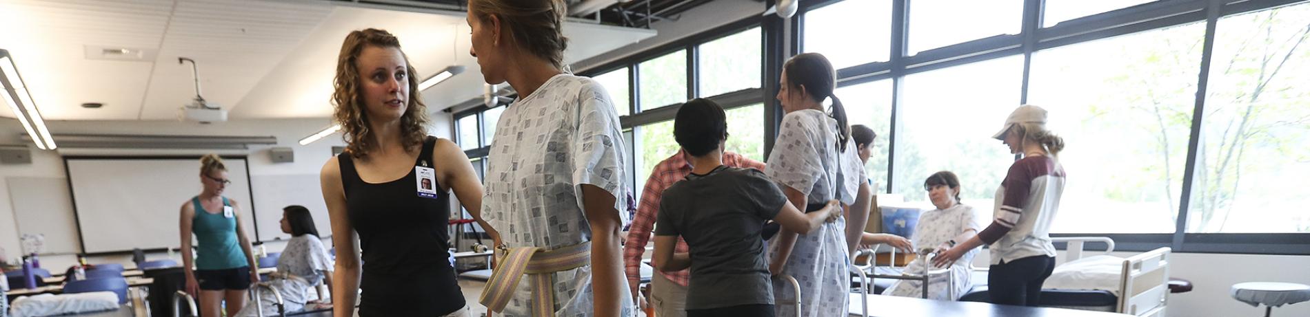 Health Professions students helping a patient