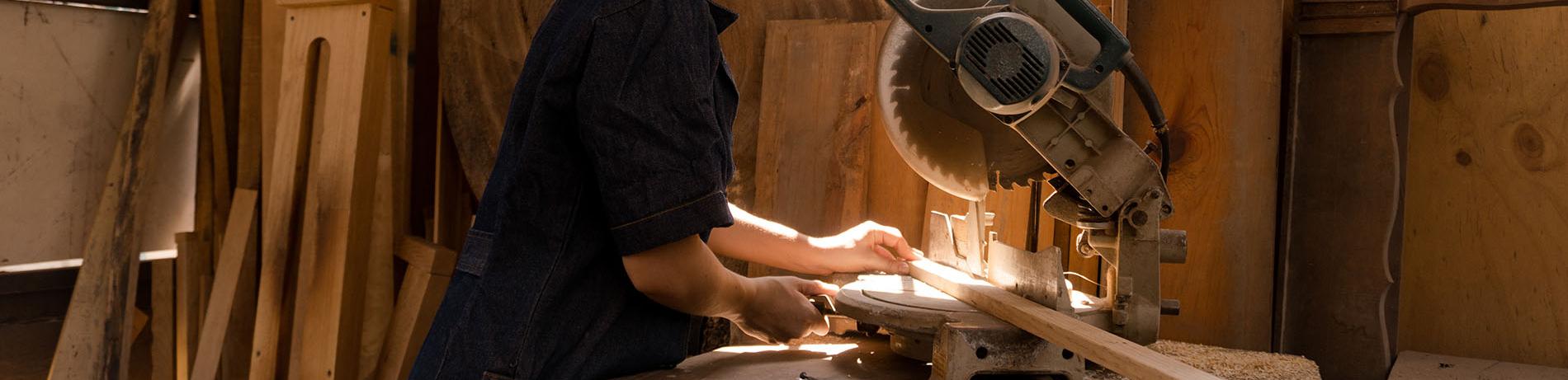 Carpenter cutting a board for a construction project