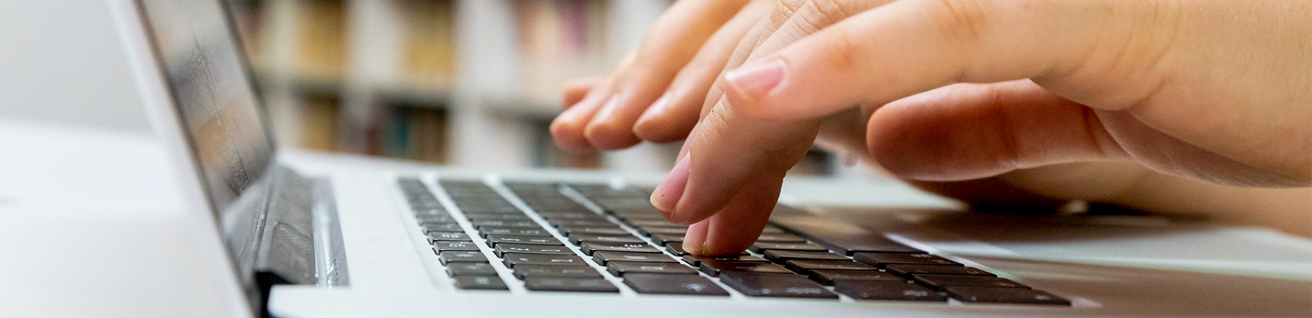 hands typing on computer keyboard