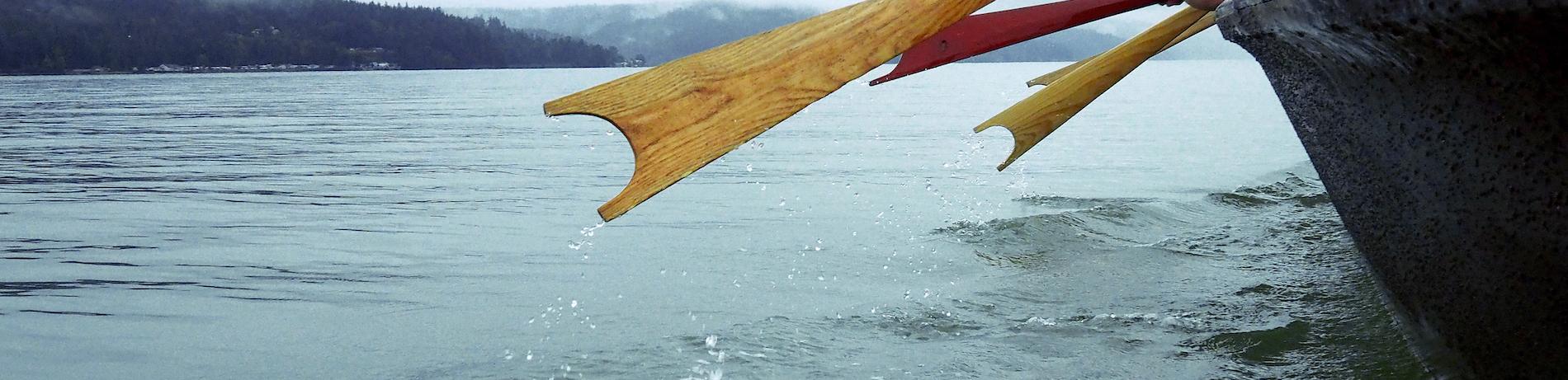 Native American paddle an ingenous boat on a Pacific Northwest lake